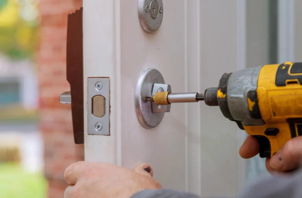 Arcadia property owner drilling new lock into house front door.