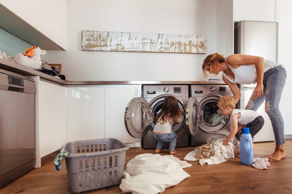 Learn how amenities increase your rental value for tenants Arcadia, CA tenant mother does laundry with two young children