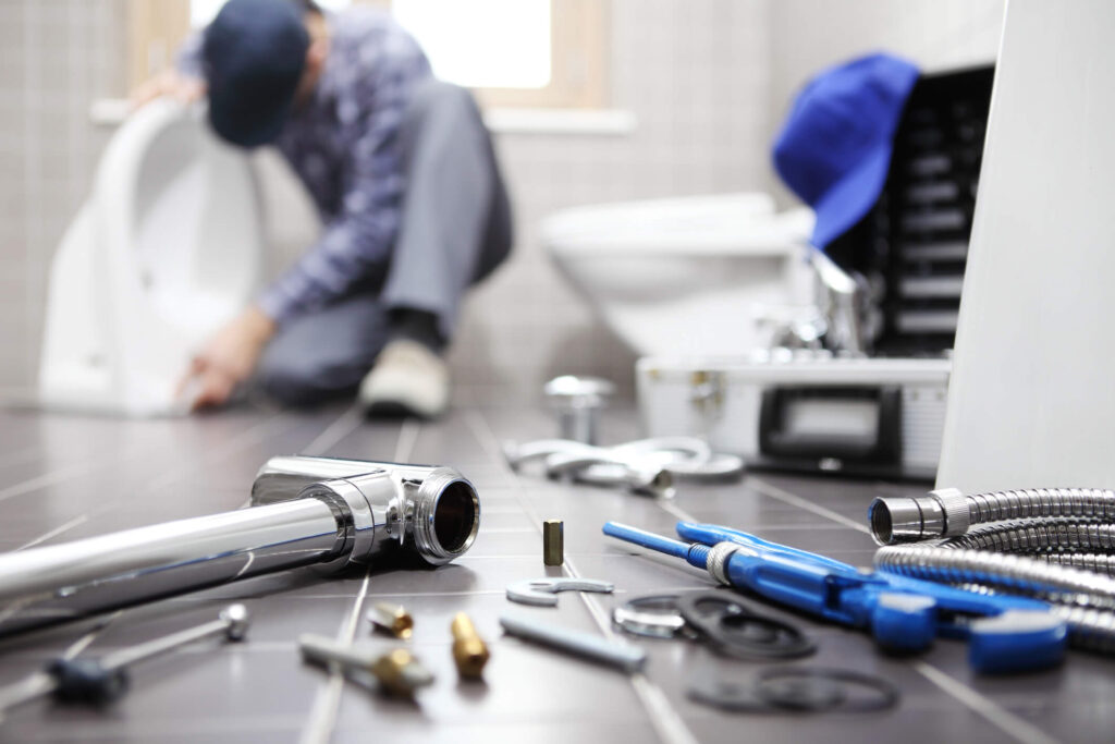 Image of plumber showing example routine rental property repairs.