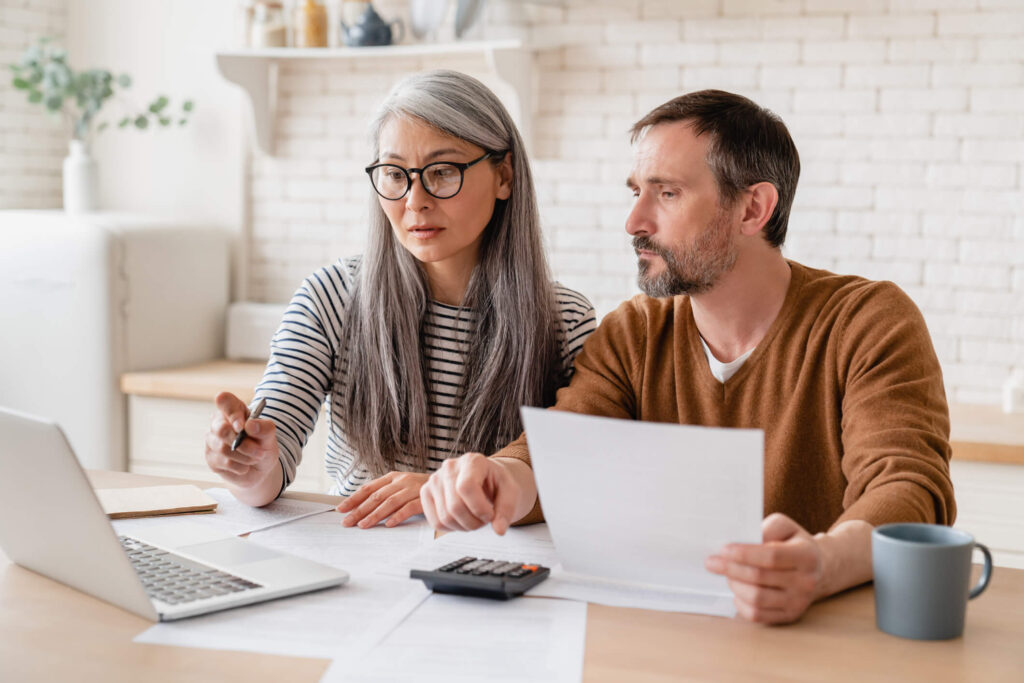 Review your California property management contract prior to switching companies. Middle-aged Covina couple review their current property management contract.